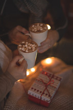 a couple drinking hot cocoa together 