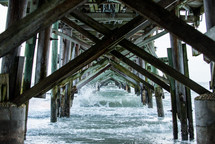 Ocean waves under a pier.