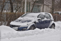 Car with winter tires on the snow covered road