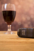 communion wine glass and Bible 