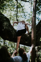 teen girls climbing a tree