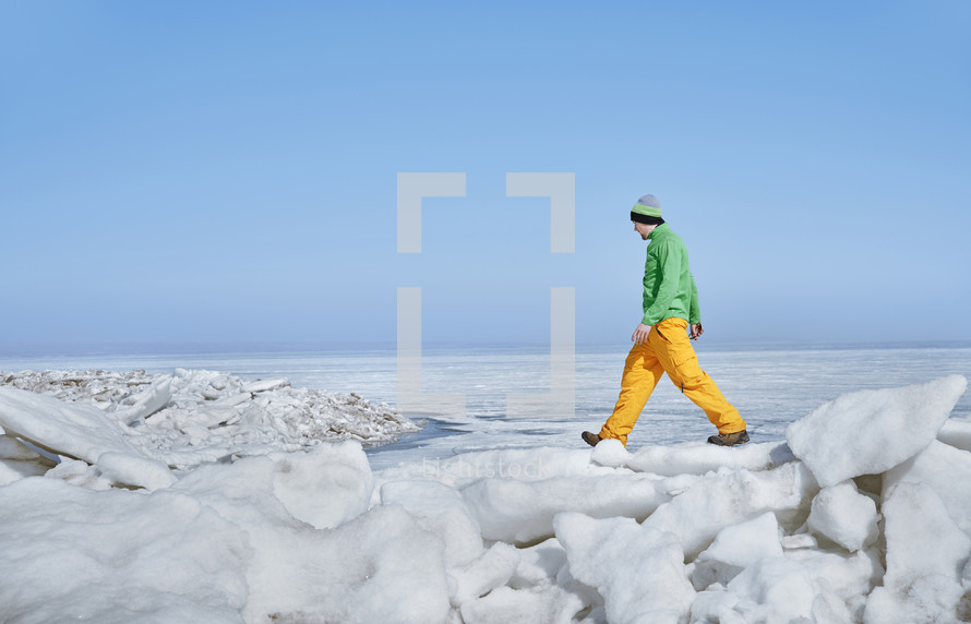 man hiking through snow 