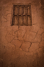 window in a red clay wall 