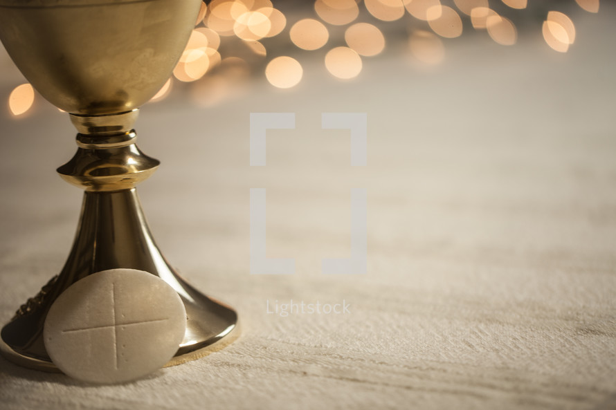 bokeh lights and chalice for communion 