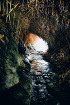water in a stream in a cave 