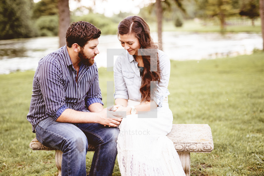 couple praying together outdoors 