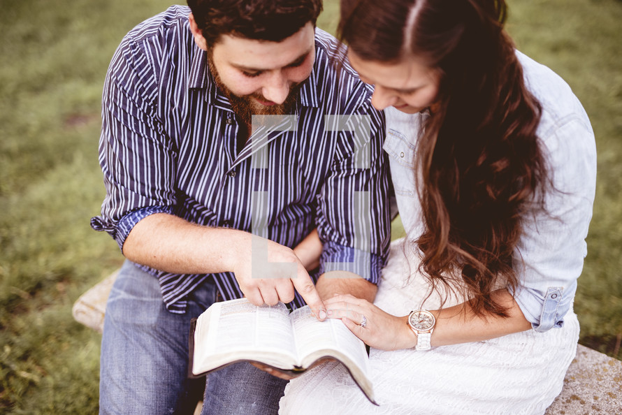 couple reading Bibles and praying together 