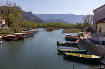 In Virpazar, Montenegro an inlet of Skadar Lake contains multiple tour boats waiting for passengers