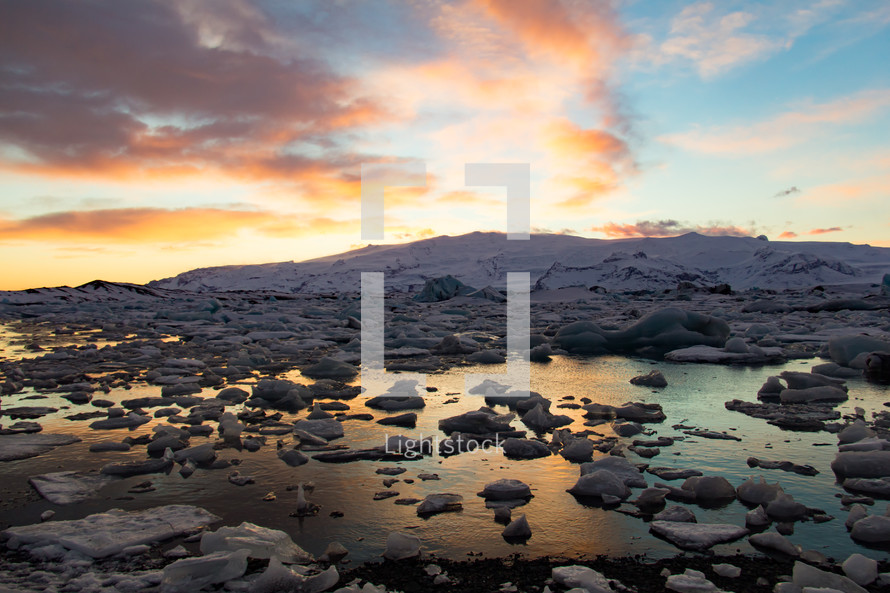 The Glacier Lagoon on the south coast of Iceland (Jokulsarlon) contains thousands of icebergs from the nearby Breidamerkurjokull Glacier. Its still waters reflect the brilliant light of a sunset.