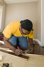 man installing a hardwood floor