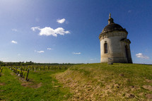 Found in the middle of a Bordeaux vineyard, a round tower chapel stands on a small hill