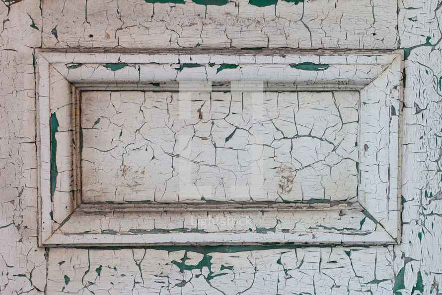 old door with cracked and peeling white paint 
