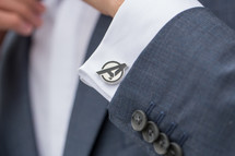 Avenger cuff link on a groom's sleeve 