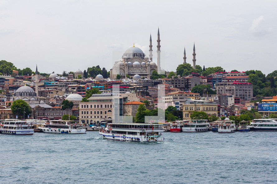 Istanbul, Turkey - View of Rüstem Paşa Camii mosque from the opposite bank on the Golden Horn, ferry boats are in the foreground