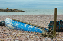 Old boat found on a beach in Sidmouth, Devon, England that is buried in the rocks