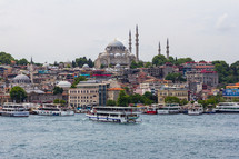 Istanbul, Turkey - View of Rüstem Paşa Camii mosque from the opposite bank on the Golden Horn, ferry boats are in the foreground