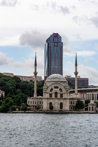 Istanbul, Turkey - View of the Dolmabah Mosque on the banks of the Bosphorus Strait, S..zer Plaza is in the background