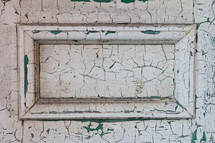 old door with cracked and peeling white paint 