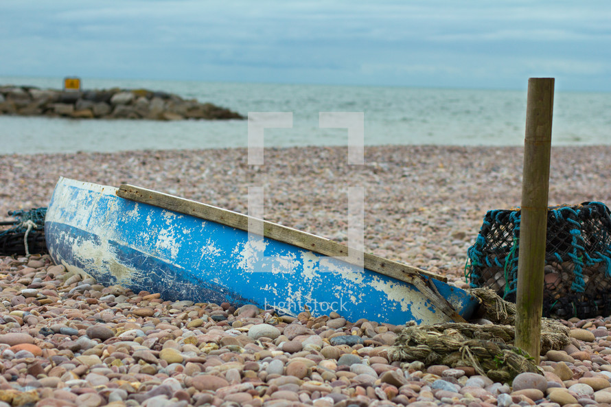 Old boat found on a beach in Sidmouth, Devon, England that is buried in the rocks