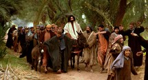 Jesus comes to Jerusalem as King riding a donkey 