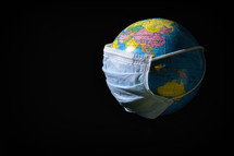 face mask on a globe 