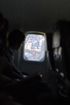 child looking out an airplane window 