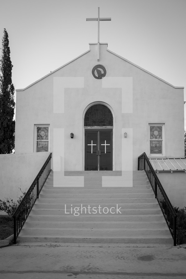 steps leading to a rural white church 