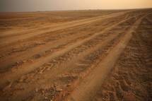 tire tracks in sand in the desert 