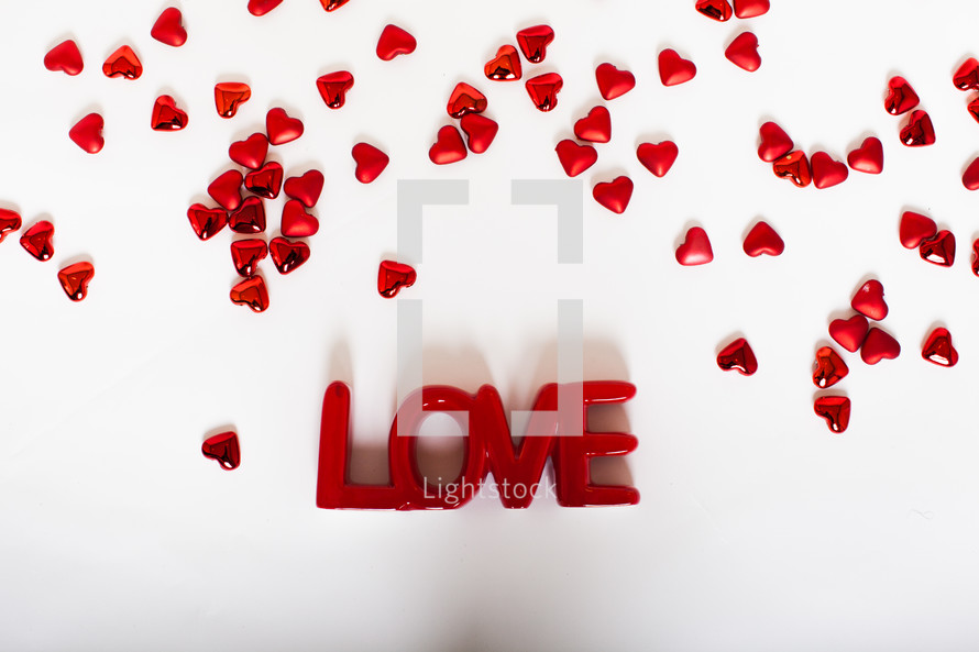 word love and red hearts on a white background 