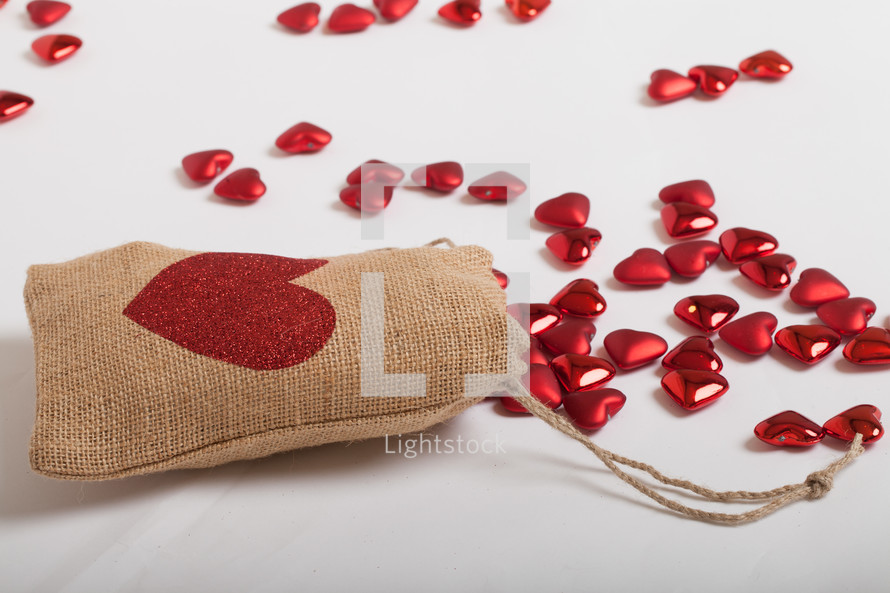 red hearts and a burlap sac on a white background 