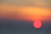 Red sunrise over hazy sea
