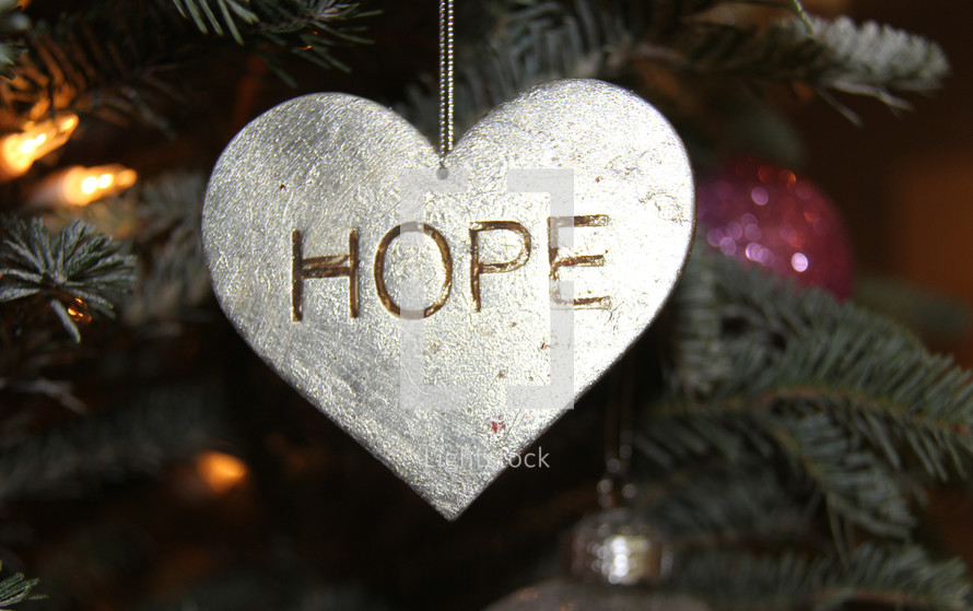 hope heart ornament hanging on a Christmas tree