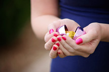 a plastic Easter egg in a woman's cupped hands 