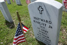 American flags and grave markers in a cemetery