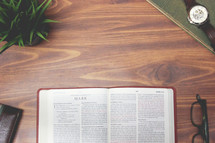 open Bible and reading glasses on a table 