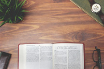open Bible and reading glasses on a wood table - 2 Thessalonians 