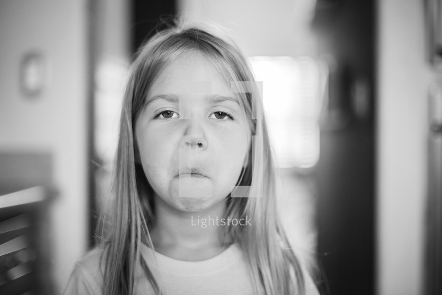 A young girl making a face.