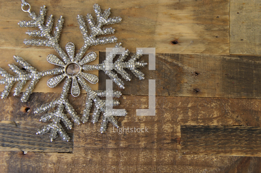 Snowflake against a wood floor background 