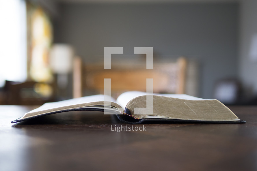 open Bible on a desk at home ready for Bible study or a small group setting or discipleship.