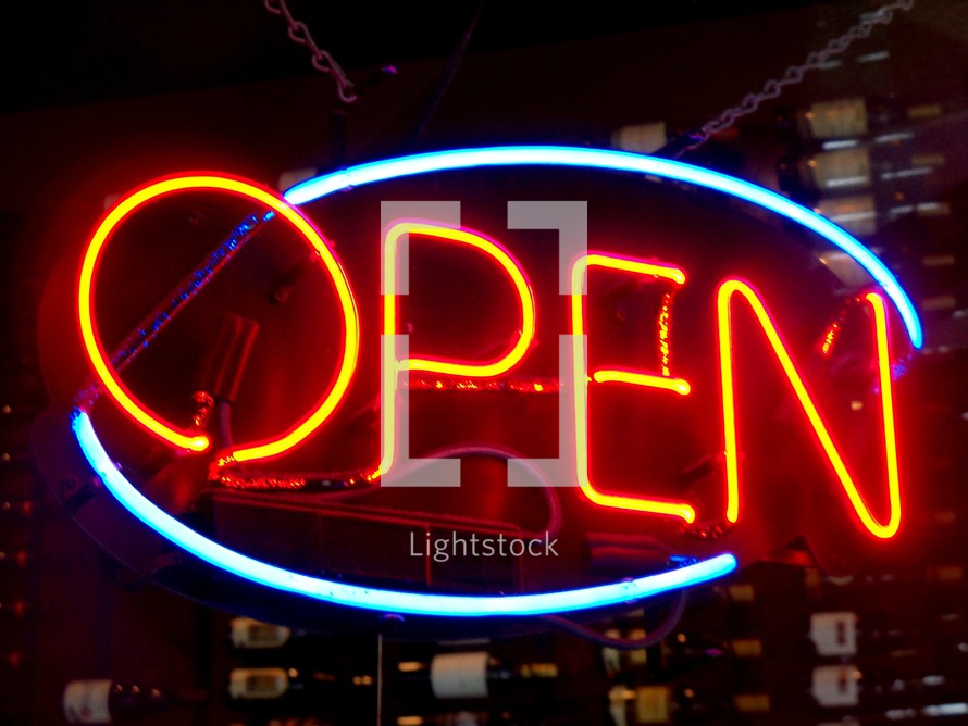 A neon yellow, read and blue open sign that tells the world it is open for business for a restaurant, business or retail establishment that lights up the night sky drawing people to the business to shop, browse and purchase items.  