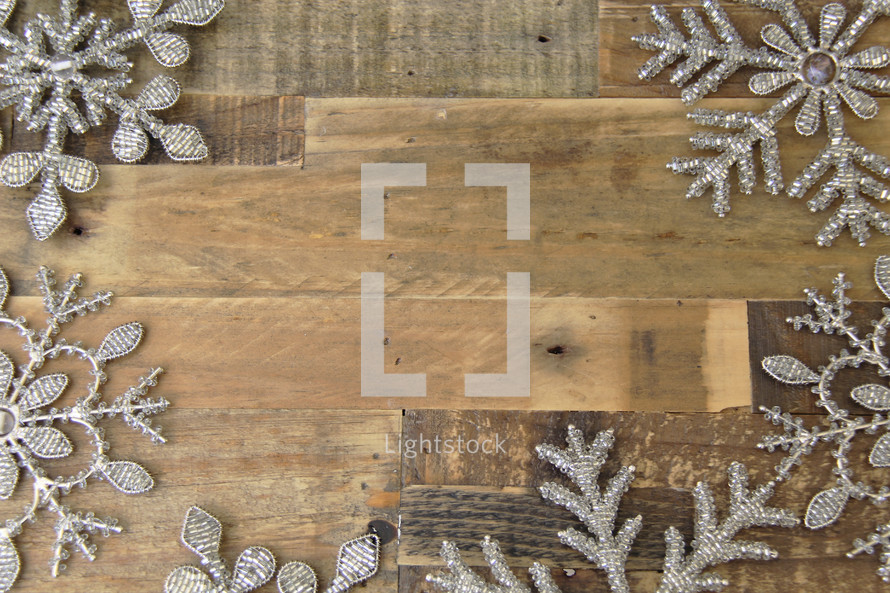 snowflake border on a wood floor background 