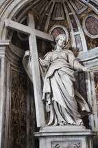 statue of a woman holding a cross 