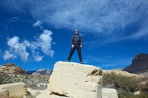 man standing on top of a rock