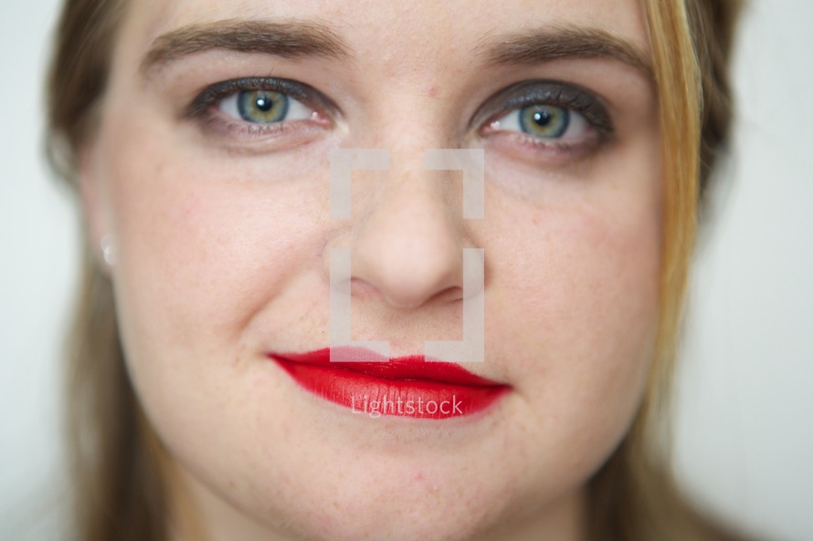 face of a woman wearing red lipstick