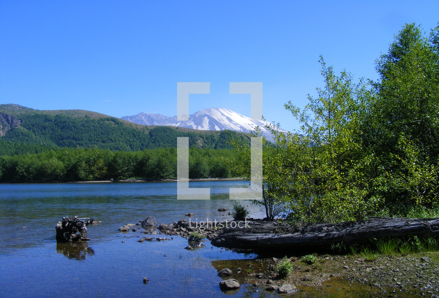 Lake shore with view of Mt. St Helens Volcano in the background