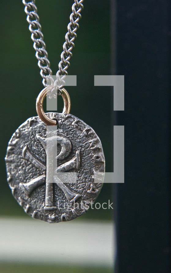 Pewter medallion on chain with chi rho emblem.