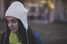 A young woman wearing a white beanie