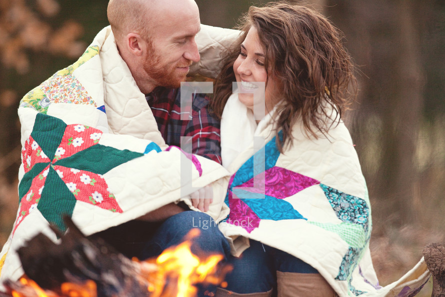 couple sitting by a fire pit 