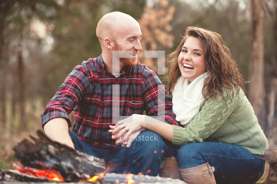 Couple by a campfire.