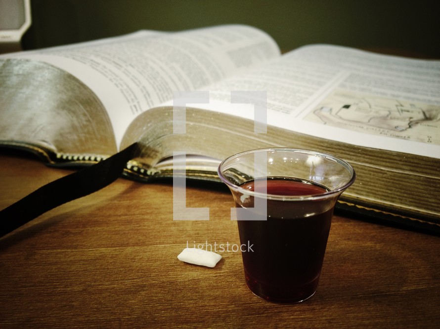 bread and wine in front of a Bible